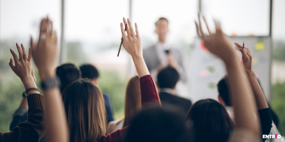 Engaging audience raising hands at a conference to ask a question