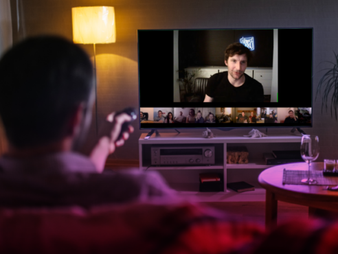 Man watching stand-up live-stream on TV via Entrio hybrid events platform