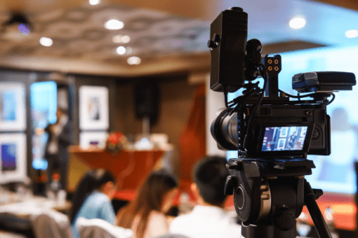 Camera recording an corporate event for live online streaming via Entrio hybrid events platform